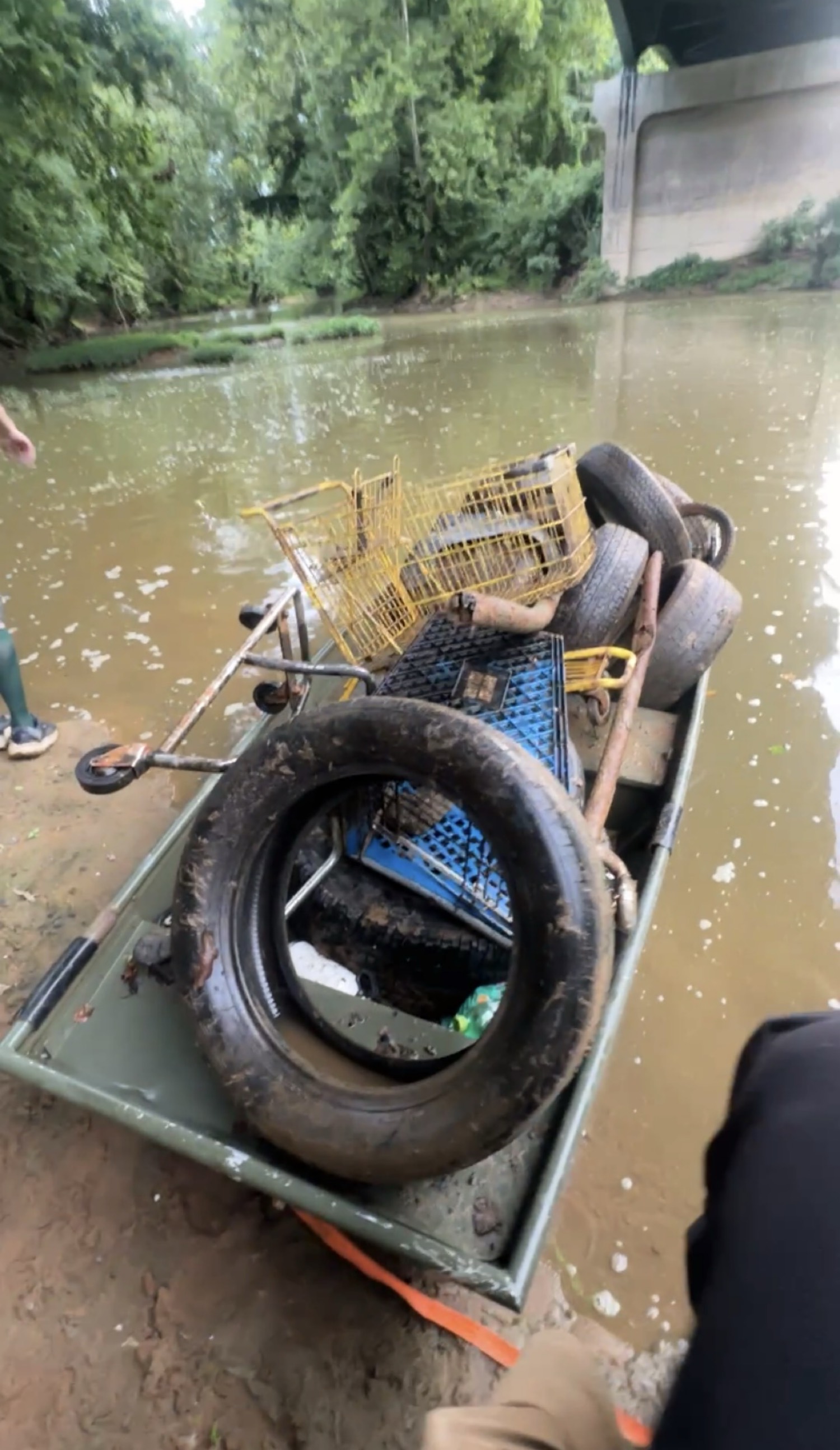 Boat carrying recovered tires and debris